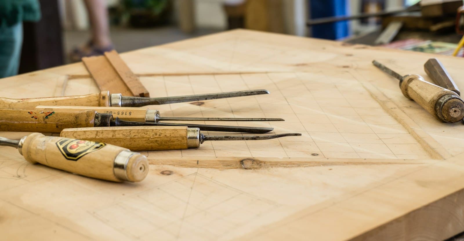 Hand tools laid out on a wooden workbench