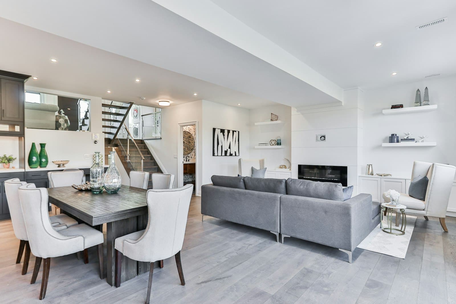 A calm open-plan living room with a dining table and sofa