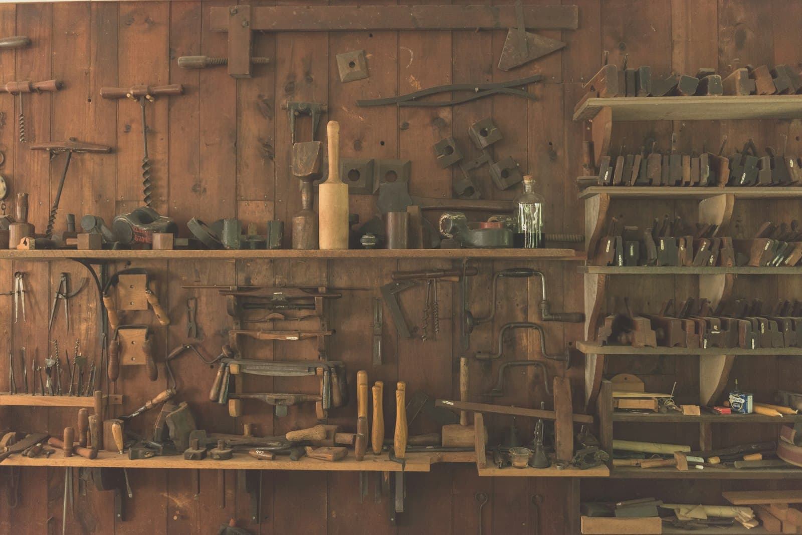 Woodworking hand tools arranged on a shelf