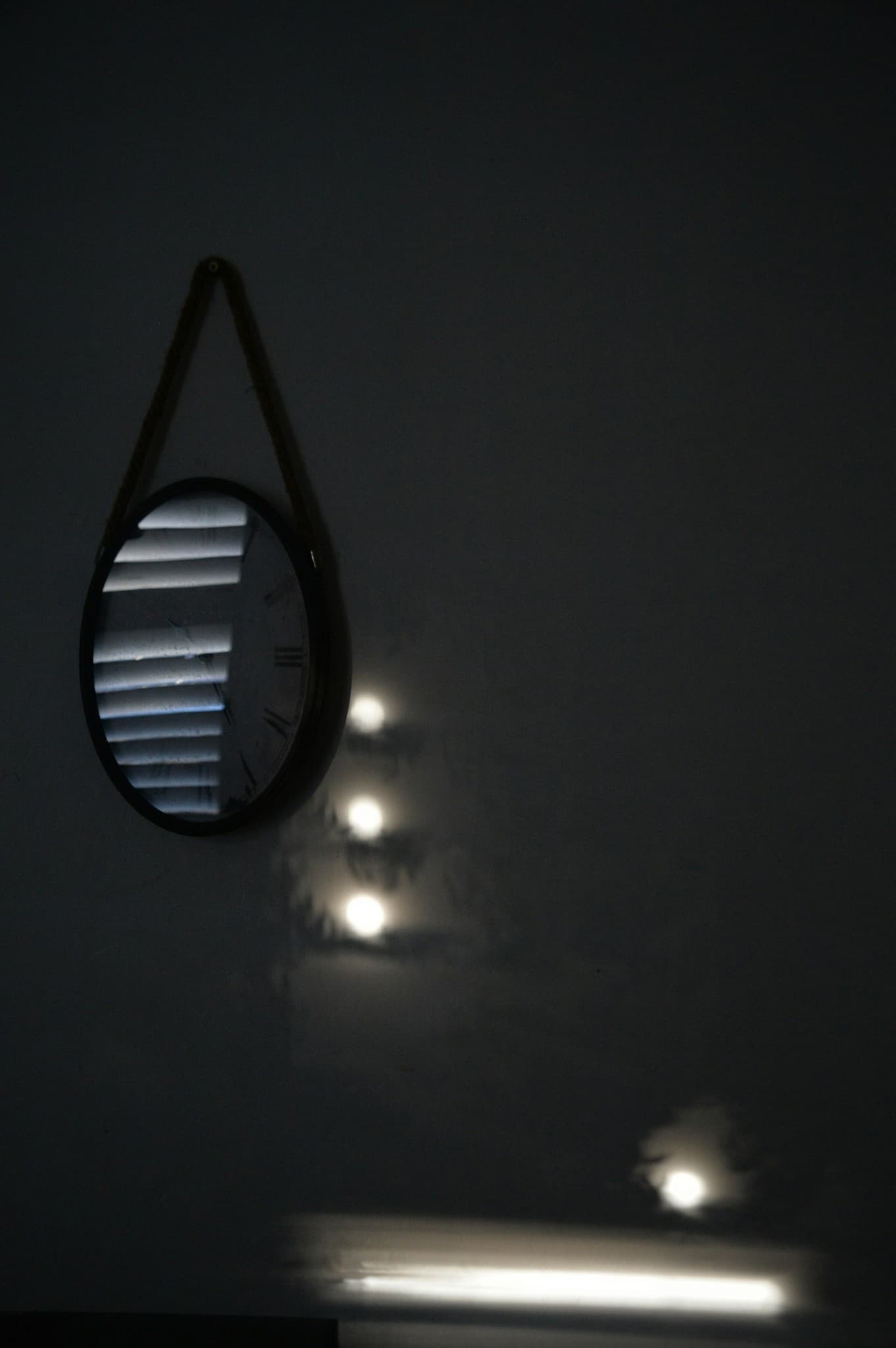A round mirror reflecting soft window light